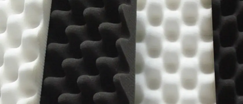 Acoustic foam wedges, hexagonal PET felt tiles, mass-loaded vinyl barriers, and fabric-wrapped fiberglass panels arranged by price tier